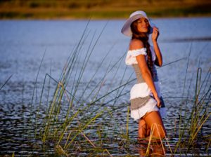Sexy model posing in lake water in sunshine